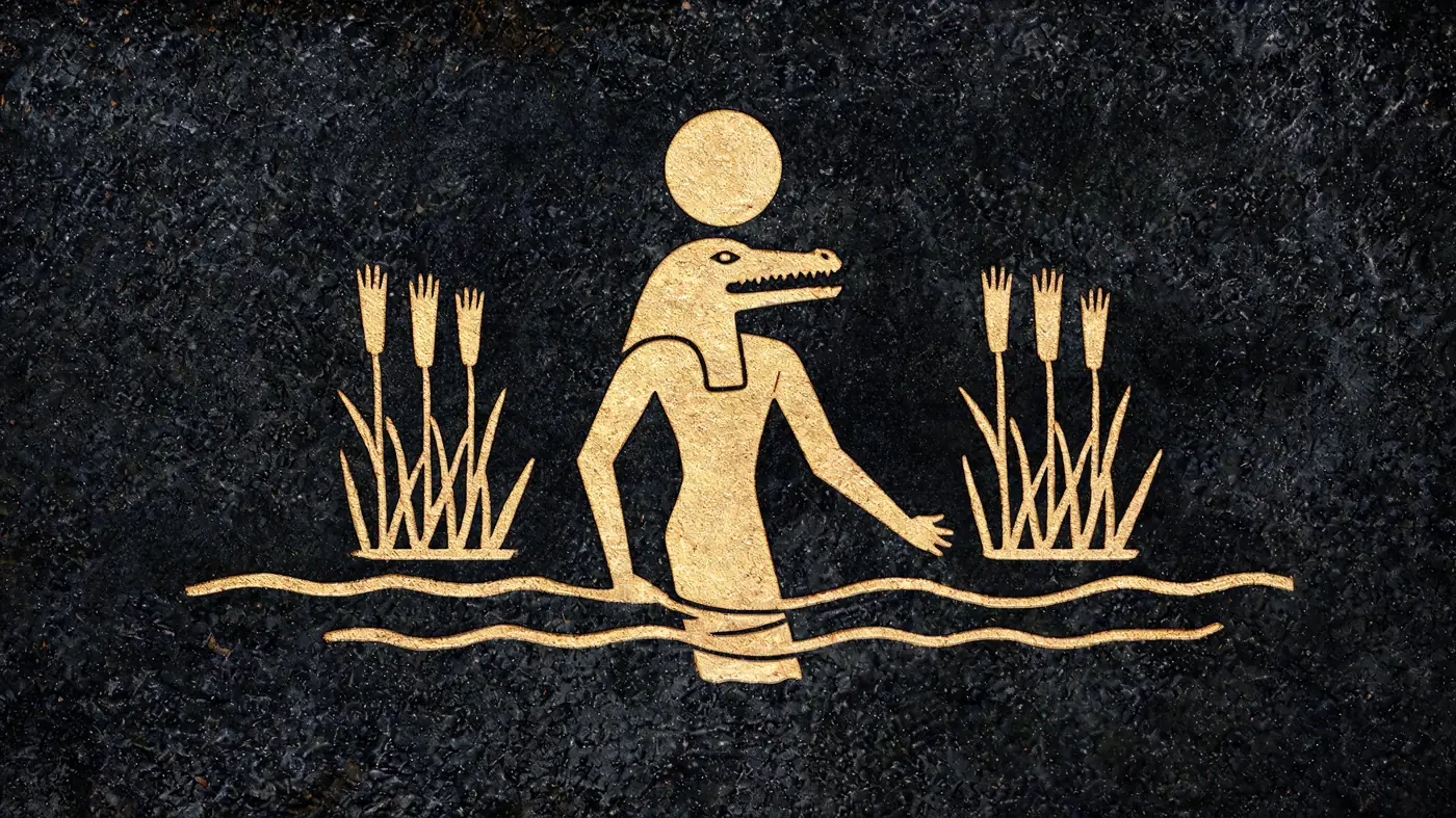 Carved stone relief in gold on black basalt: Sobek rising from the Nile among the reeds — Egyptian mythology, Neolithic Store