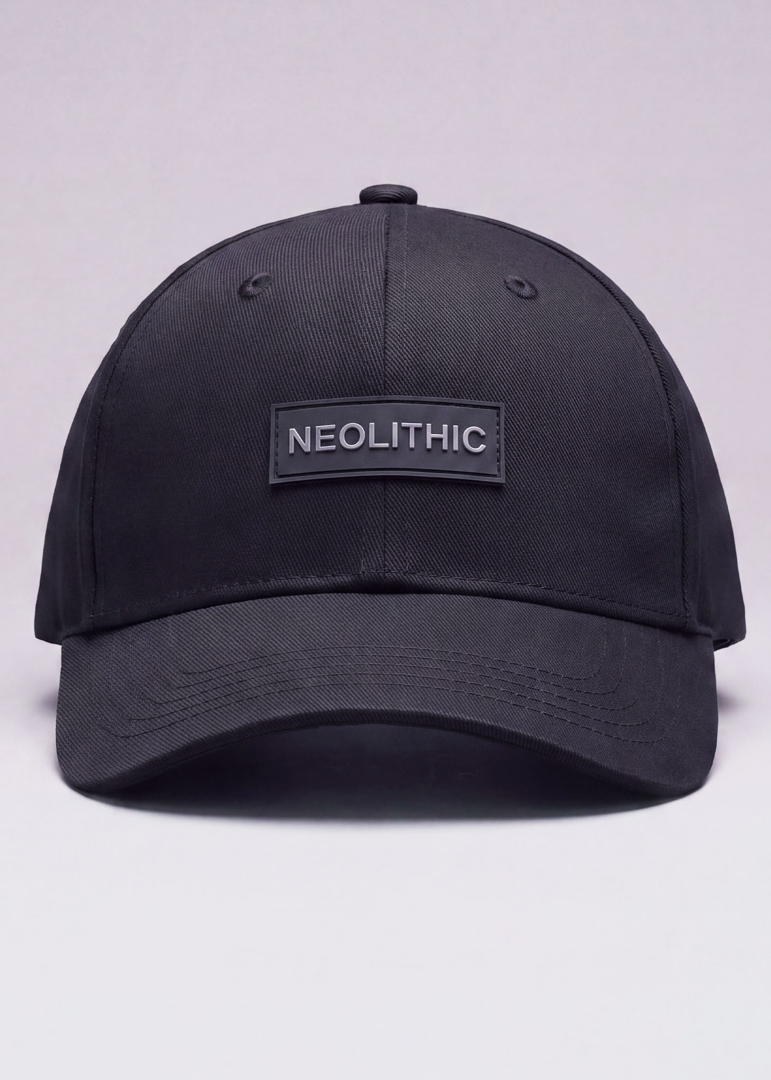 Neolithic Emblem Cap in black — rubberized-patch six-panel mythology streetwear cap